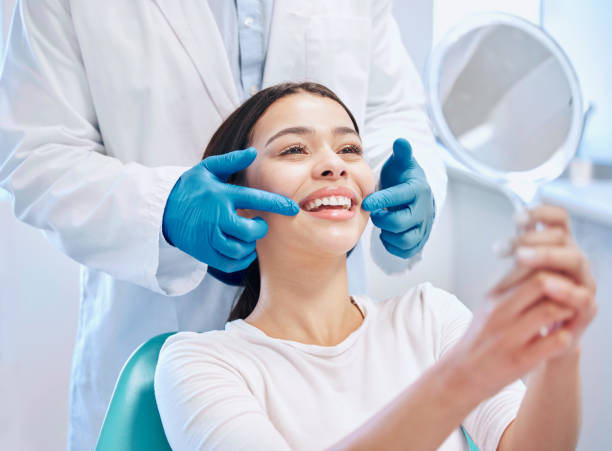 shot of a young woman checking her results in the dentists office - diş sağlığı lar stok fotoğraflar ve resimler