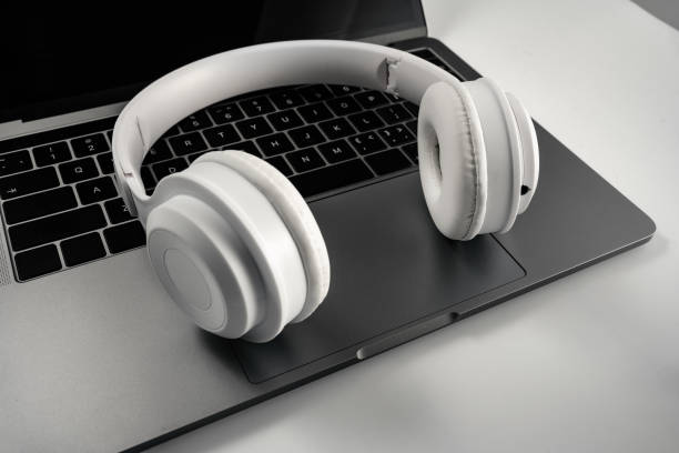 istock Laptop and headset on white background 1388932994