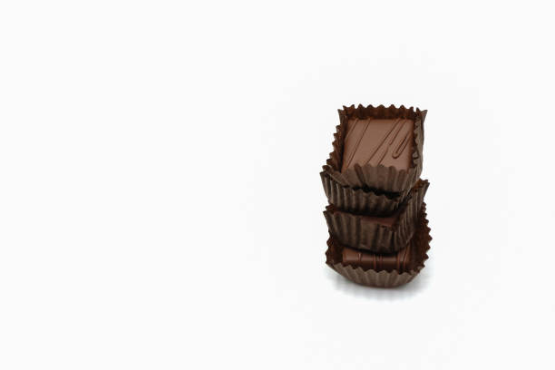 istock Chocolate candies in paper cups on a white background. 1388934460