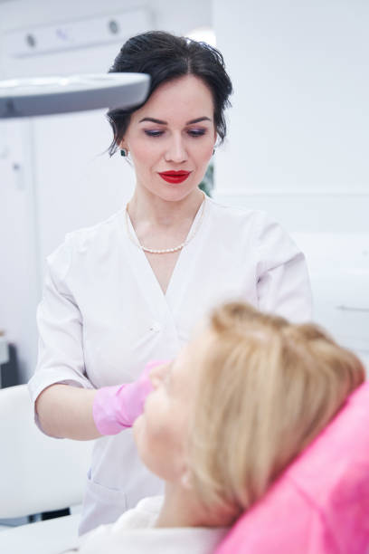 istock Young beauty master consulting her aged patient 1388934661