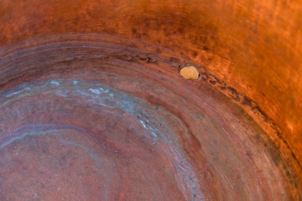 Copper background. The inner of a copper cauldron with blue circles. Oxidation. Soldering on a copper surface.