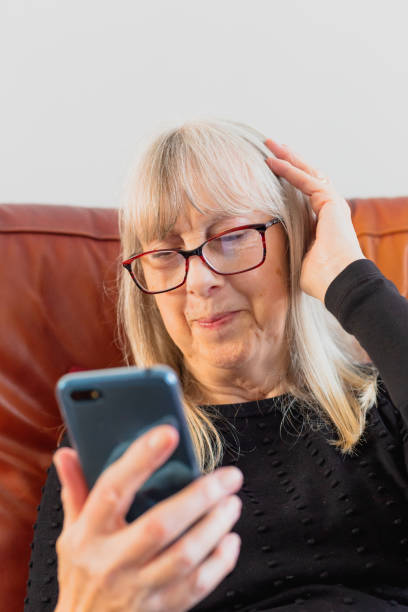 istock Happy senior woman using smart phone at home 1388935995