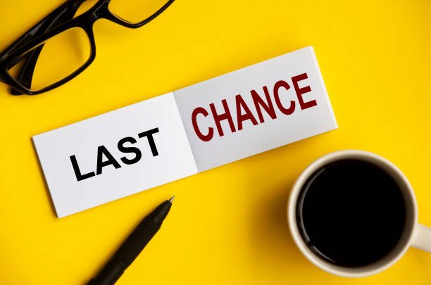 istock Last chance text on notepad with glasses, pen and coffee cup. 1388936188
