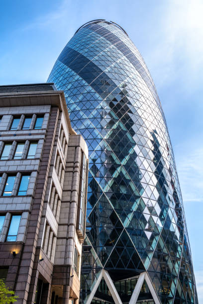 The Gherkin or St Mary Axe building in the city of London. This iconic structure is home to many global businesses such as Sky News and Swiss Re. London, UK - 25 March 2022: The Gherkin or St Mary Axe building in the city of London. This iconic structure is home to many global businesses such as Sky News and Swiss Re. sky news stock pictures, royalty-free photos & images