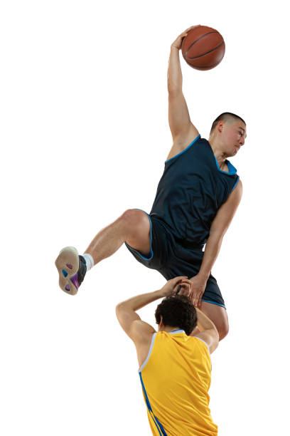 istock Two young professional basketball players in action, motion isolated on white studio background. Active lifestyle, sport, tournament concepts. 1388940524