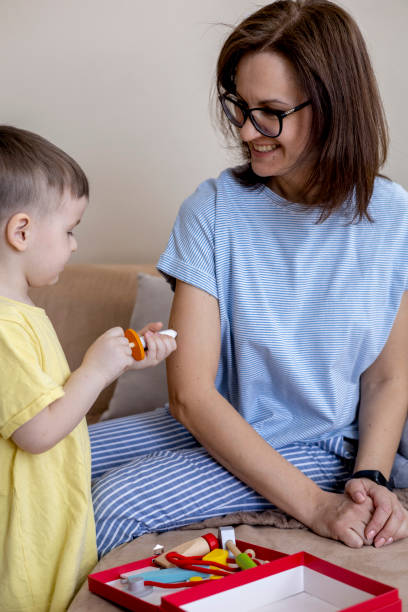 istock Montessori material. Mom and son play doctor. Profession game. 1388942018