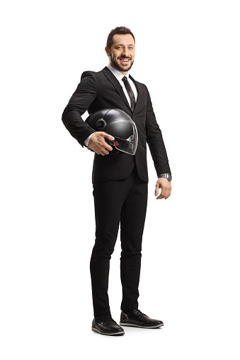 Full length portrait of a businessman holding a helmet isolated on white background