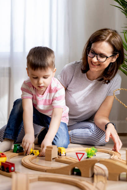 istock Montessori material. Mom and son learn transport through the game. Wooden railroad. 1388943607