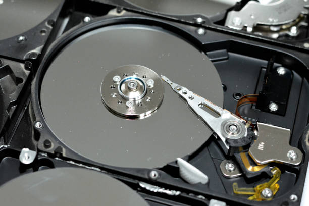 istock Computer hard disk drive storage memory, repair broken computer part, close up of open hard disc with platters, spindle, actuator and read, write head 1388943704