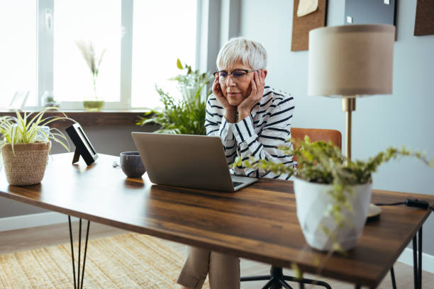 istock Senior business woman working from home 1388943873