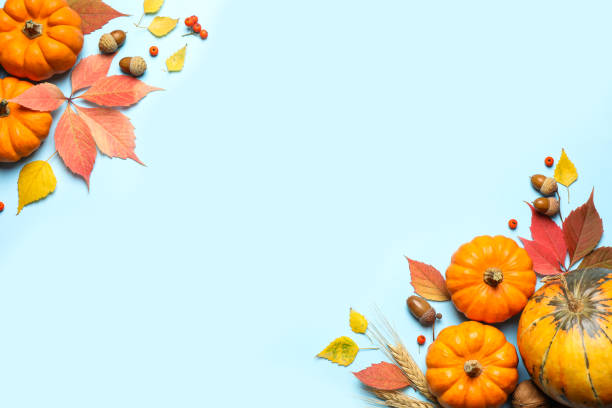 istock Flat lay composition with pumpkins and autumn leaves on light blue background, space for text. Thanksgiving Day 1388947116