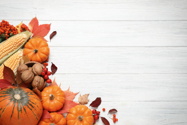 istock Flat lay composition with vegetables, berries and autumn leaves on white wooden table, space for text. Thanksgiving Day 1388947302