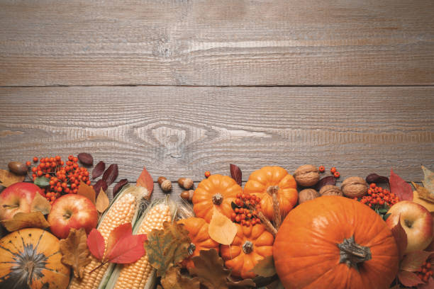 istock Flat lay composition with vegetables, berries and autumn leaves on wooden table, space for text. Thanksgiving Day 1388948484