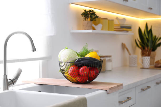 istock Basket full of different vegetables on wooden board in modern kitchen 1388948579