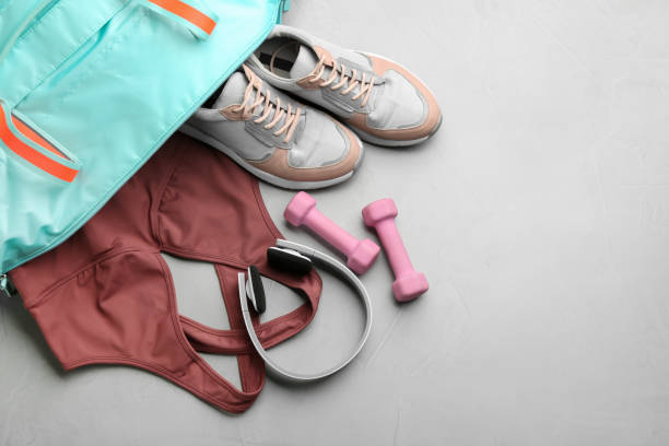 istock Flat lay composition with gym bag and sportswear on grey table. Space for text 1388948743