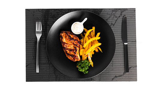 French fries with grilled chicken fillet isolated on a white background. Fried potatoes with sauce. High quality photo