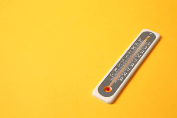 istock Weather thermometer on yellow background. Space for text 1388949699