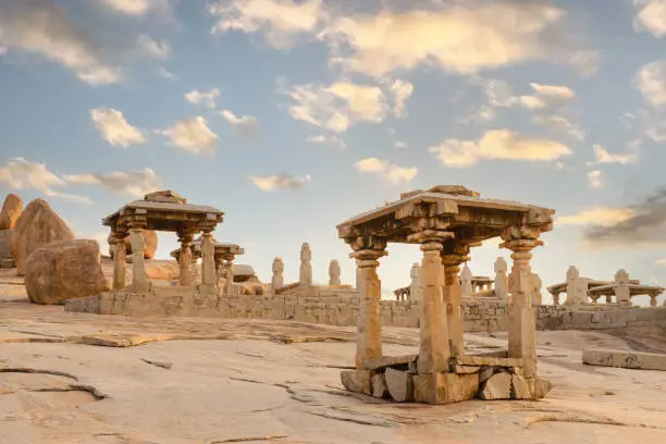 Beautiful architecture of ancient ruins of temple in Hampi at sunset, Karnataka, India