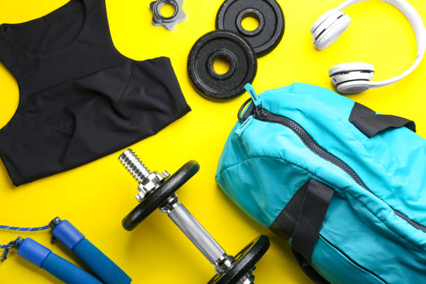 istock Flat lay composition with gym bag and sportswear on yellow background 1388949992