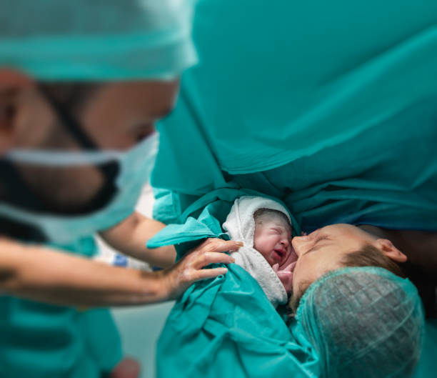 Baby and Mother in Delivery Room Mother, Newborn, Baby - Human Age, Childbirth, Surgery childbirth stock pictures, royalty-free photos & images