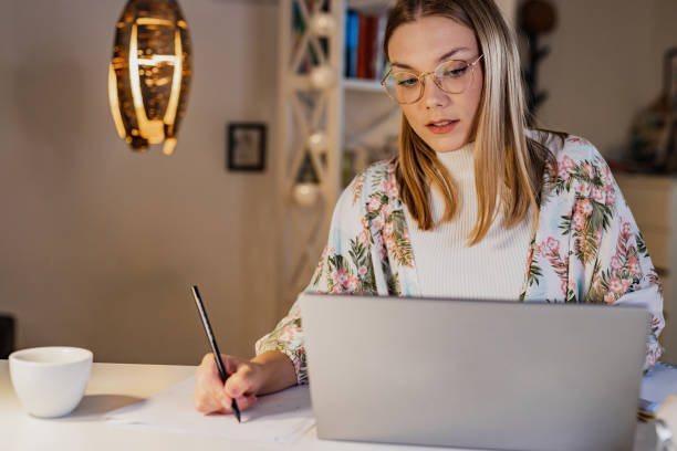istock Young woman freelancing from home 1388952455