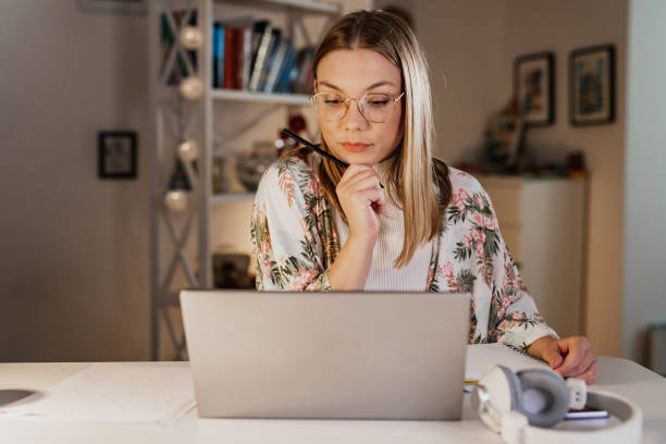 istock Young woman concentrating while looking at the laptop 1388952708