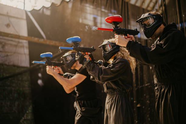 Men and women playing paintball