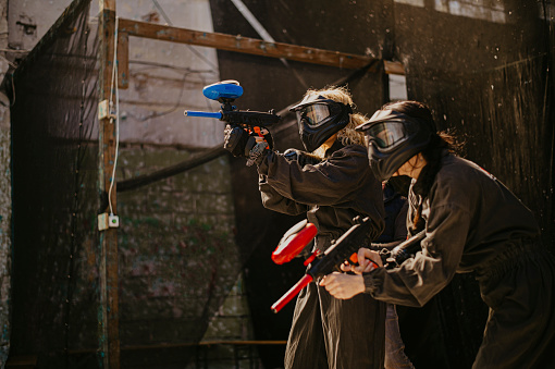 Men and women playing paintball