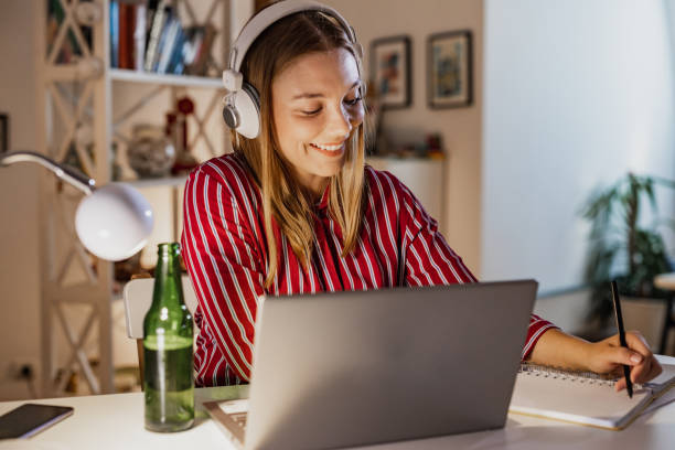 istock Young woman working late and relaxing with beer 1388953788