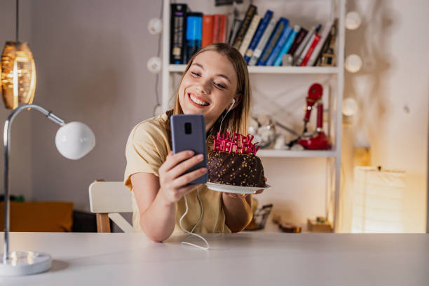 istock Young woman taking a selfie on her birthday 1388955734