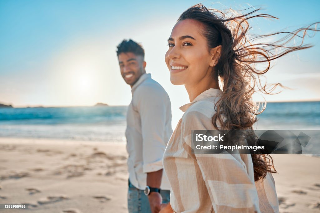 Shot of a young couple spending time together at the beach Life's a beach with you Couple - Relationship Stock Photo