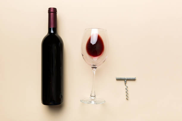 istock Flat lay composition with corkscrew, bottle of wine and elegant glass on colored table. Flat lay, top view wth copy space 1388958393
