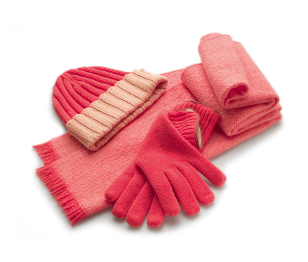 soft pink scarf with gloves and cashmere wool hat on white background