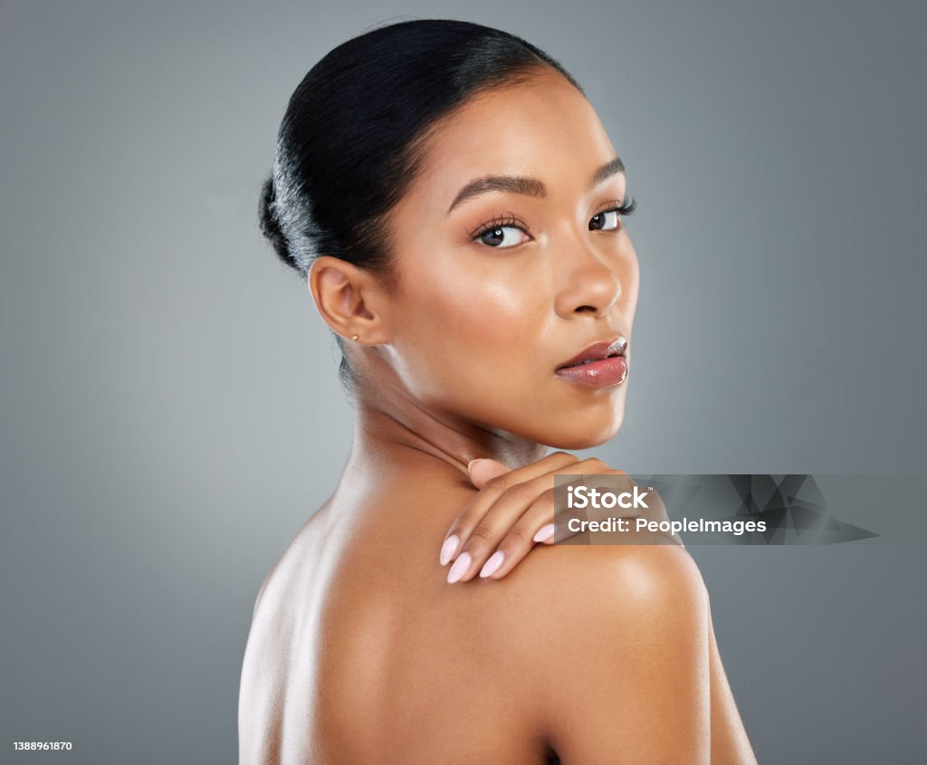 Shot of a beautiful young woman posing against a grey background It's funny that you thought that I wasn't good enough Skin Stock Photo