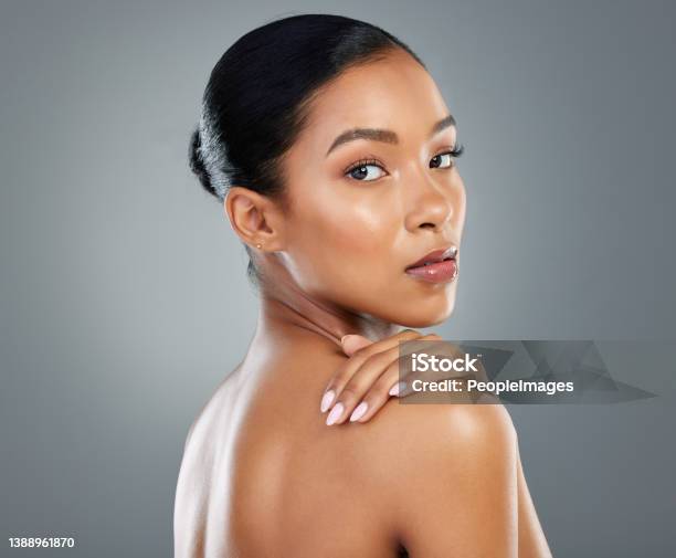 Shot Of A Beautiful Young Woman Posing Against A Grey Background Stock Photo - Download Image Now