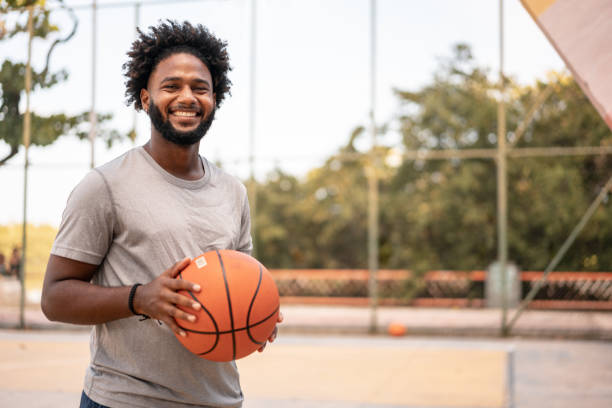 Man holding basketball ball stock photo