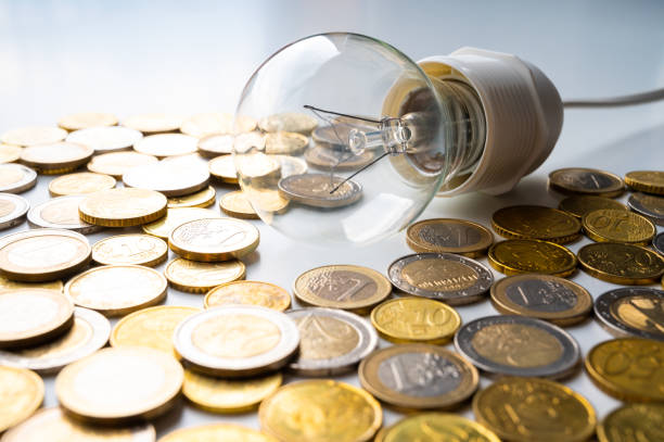 istock Light bulb with coins around. Energy costs. 1388968434