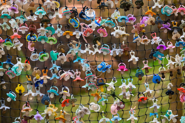 istock Baby pacifiers on the fence. 1388968718