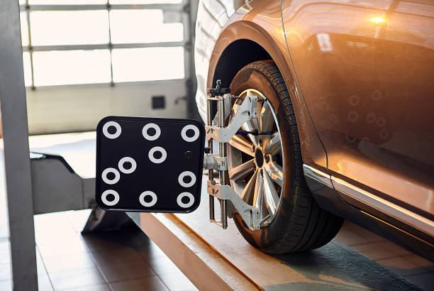 istock Diagnostics and configuration collapse-convergence. Car Wheels alignment equipment on stand in a repair station 1388970058