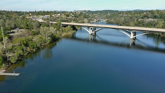 American River with bridges spanning over as it winds through Folsom, California.