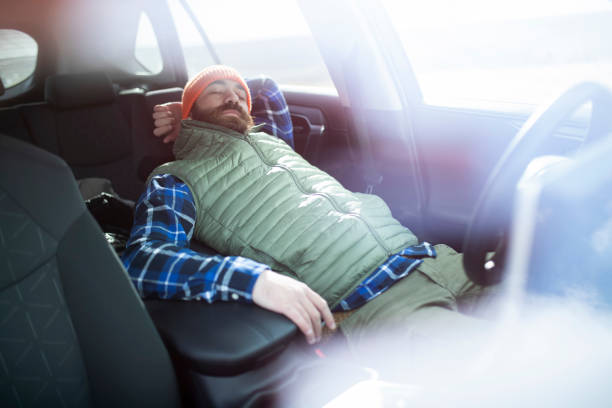 istock A bearded man resting from a long drive and sleeping in his car. ISL 1388971809
