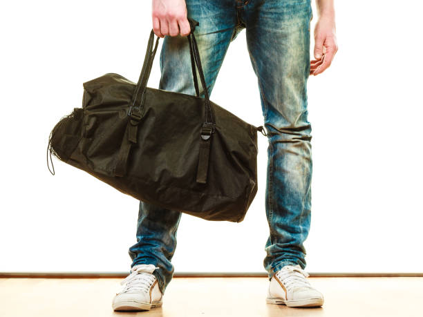 istock Young man casual style with bag isolated 1388973987