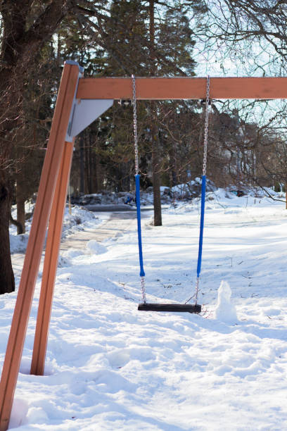 istock Swing on the children playground in winter 1388979832