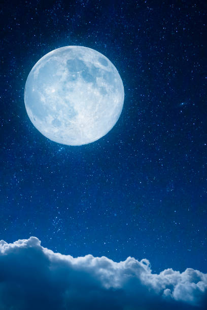 Full moon above the clouds stock photo