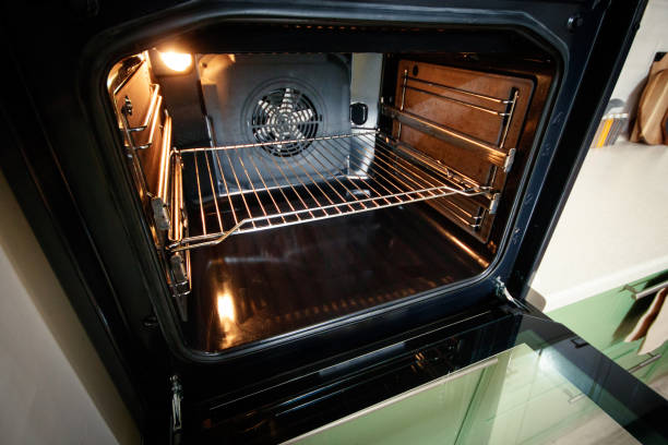 istock Open built-in oven with lighting in the home kitchen 1388990979