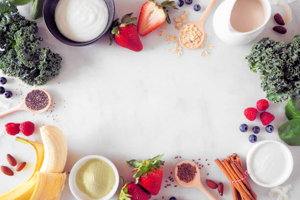 istock Healthy food frame on a white marble background with copy space. Smoothie making concept. 1388990982