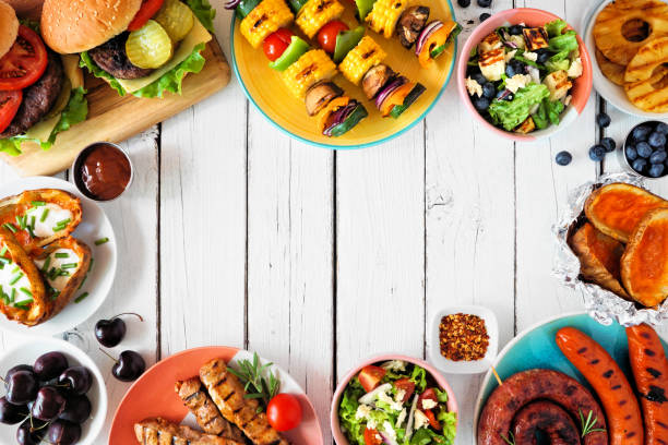 istock Summer BBQ or picnic food frame on a white wood background 1388991136
