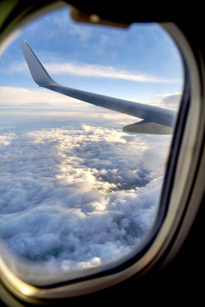 istock Clouds and sky as seen through window of an airplane during flight 1388991665