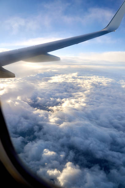 istock Clouds and sky as seen through window of an airplane during flight 1388992226