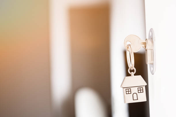 istock House key in a withe door. New home concept 1388994109